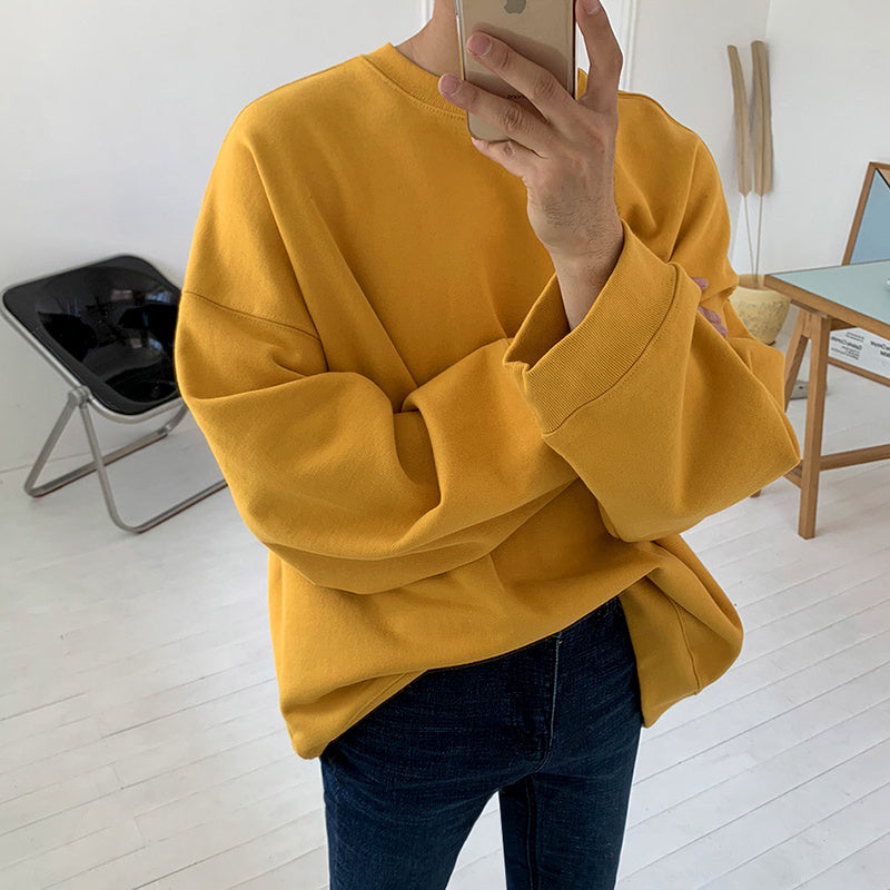 Round Neck Sweater Men's And Women's in yellow fabric worn by a person standing indoors