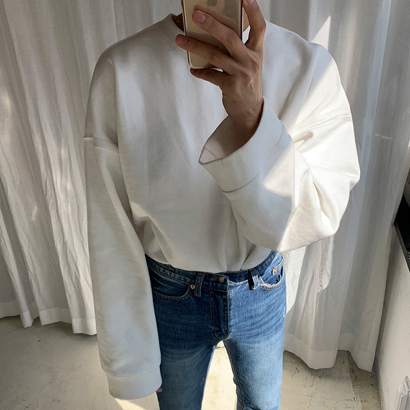 Round Neck Sweater Men's And Women's in soft fabric, styled with blue jeans, perfect for layering during cooler seasons.