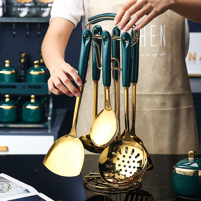 7 PCS Stainless Steel Silicone Kitchen Utensil Slotted set displayed with gold accents and green handles in a modern kitchen.