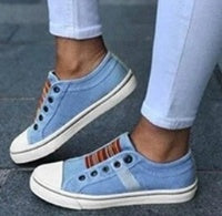 Round head stretch canvas shoe worn with white jeans, showcasing a stylish and comfortable design.