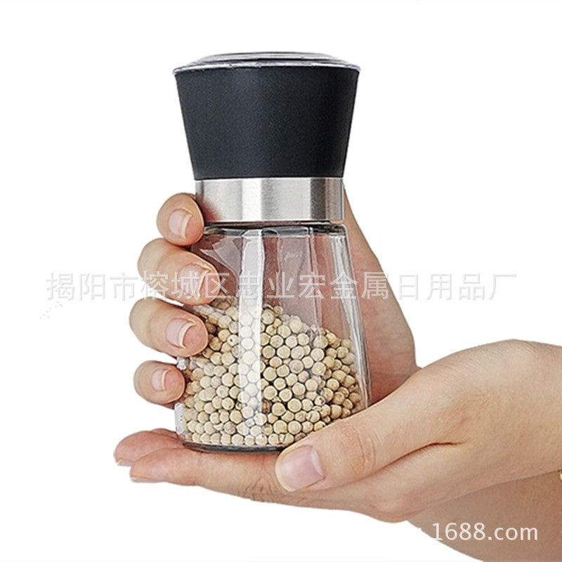 Creative kitchen appliances hand glass grinder held in hand, ideal for grinding spices and pepper.
