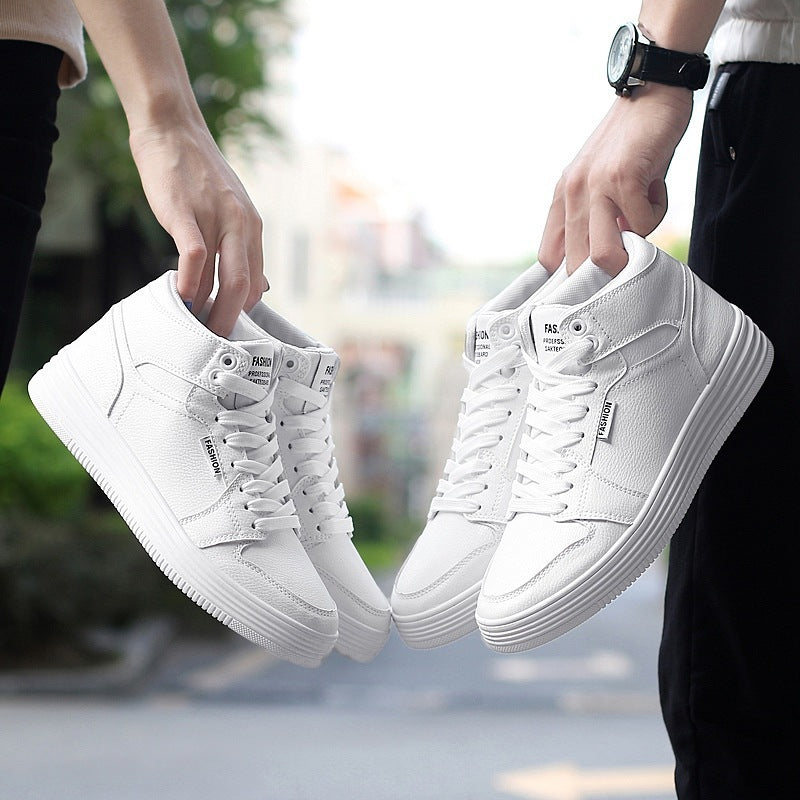 Round Head High-Top Strap Flat White Shoes Men held by person in a blurred outdoor setting.