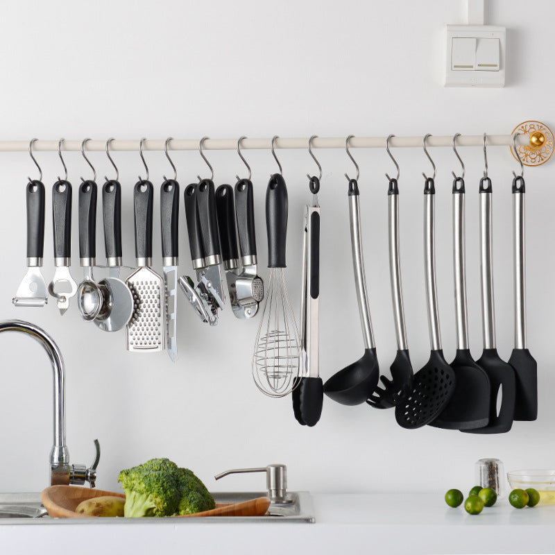 Kitchen Gadgets Cooking Silicone Spatula Spoon Set hanging above a sink with fresh vegetables in the foreground.