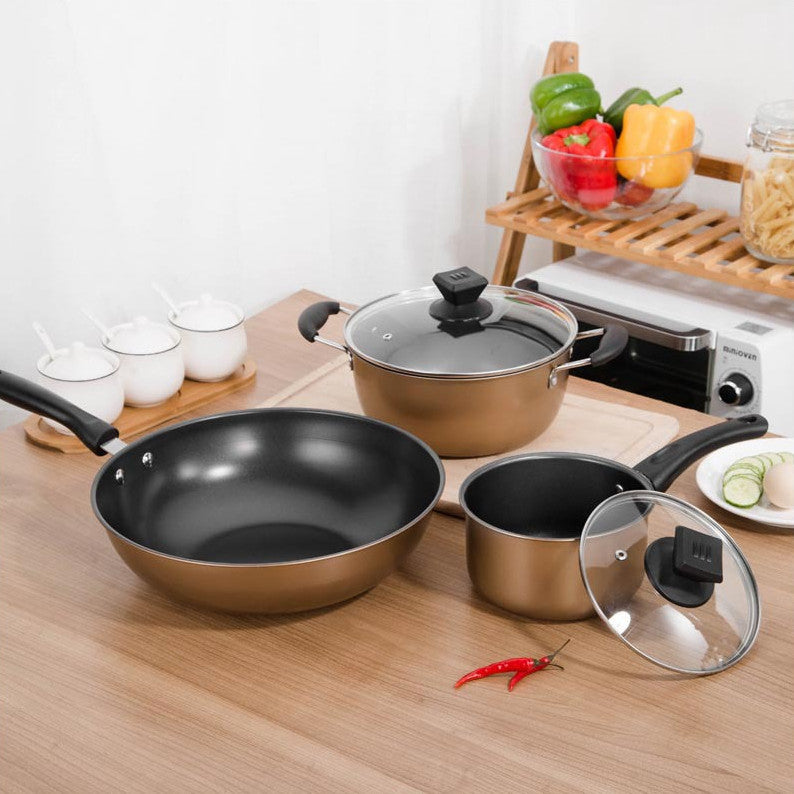 Set Of Pot Kitchen Cookware Cooking Pots displayed on a wooden kitchen counter with fresh vegetables and spices.