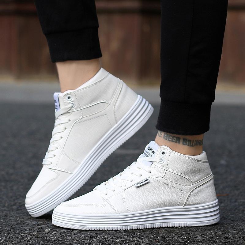 Round Head High-Top Strap Flat White Shoes Men worn by a person in black pants on the street.