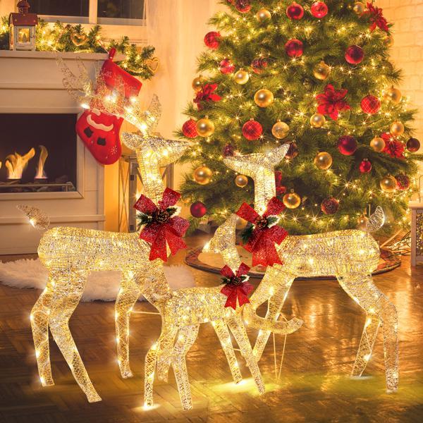 Golden Elk Family Courtyard Elk Decoration displayed with festive lights near a Christmas tree and fireplace.