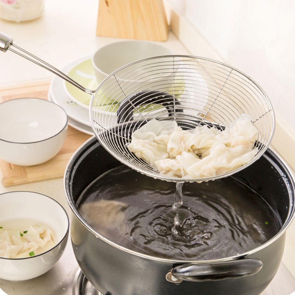 Kitchen Cooking Utensils Net Drain lifting dumplings from boiling water in a pan, ideal for effortless cooking.