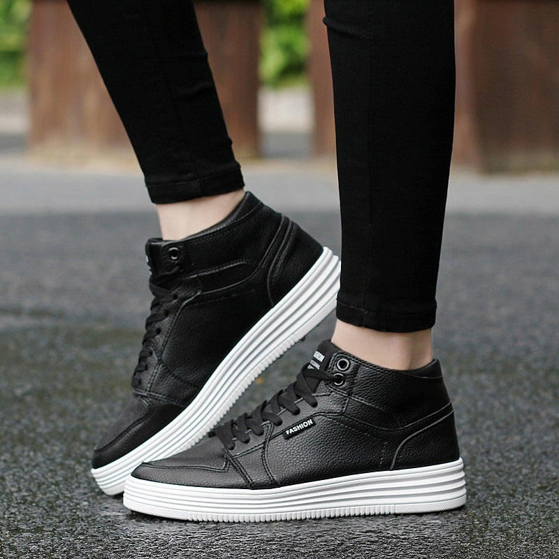 Round Head High-Top Strap Flat White Shoes Men worn with black pants on a wet surface.