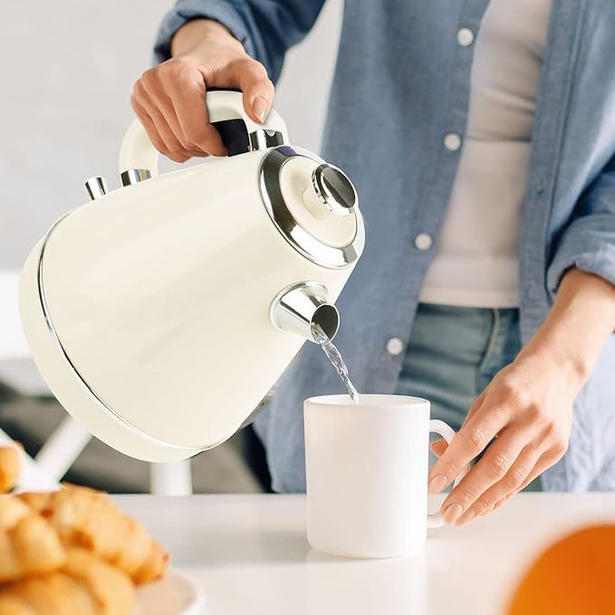 Household Small Appliances Electric Kettle pouring water into a white mug in a modern kitchen.