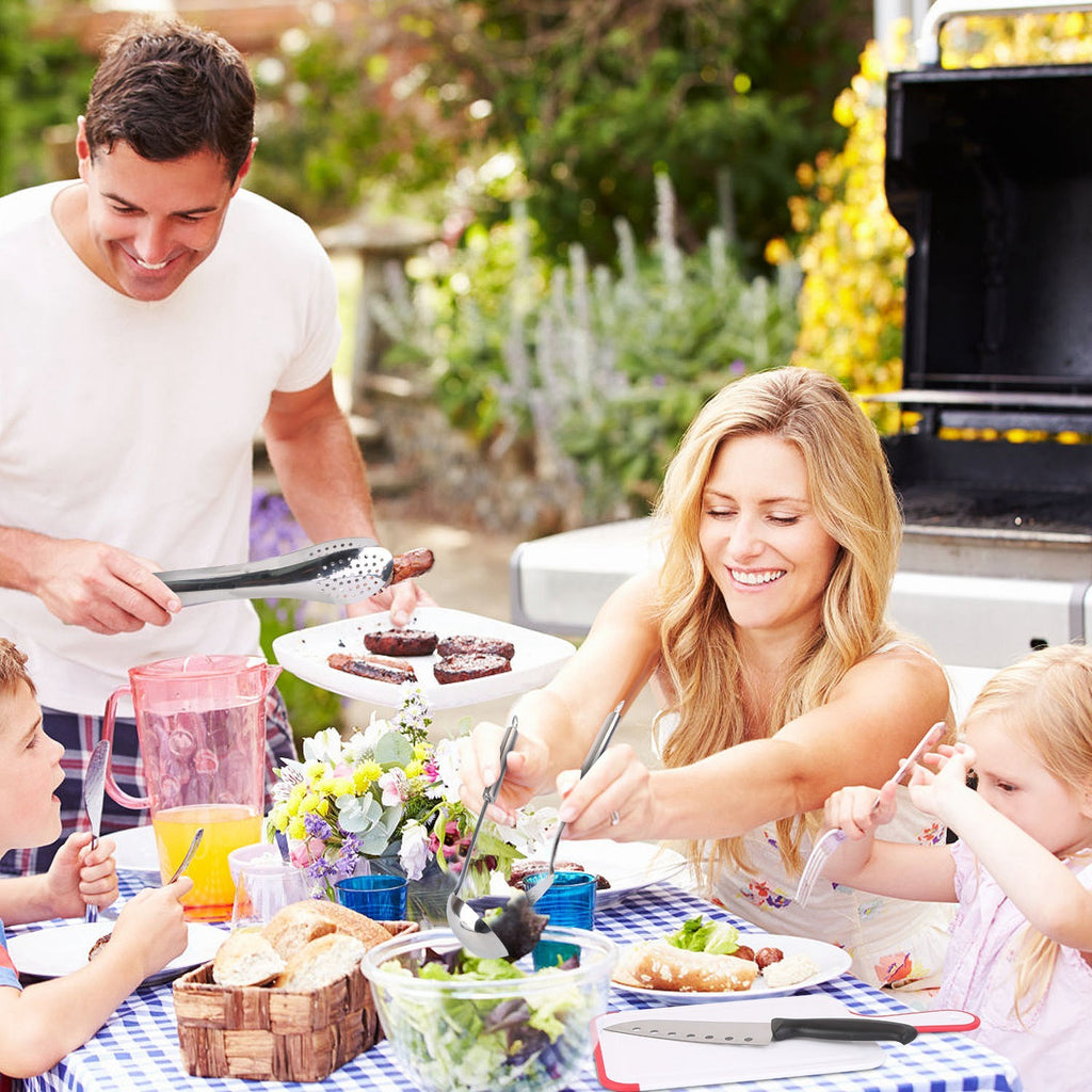 Family enjoying a meal outdoors with the Camping Cooking Utensil Kit Portable Picnic Cookware.