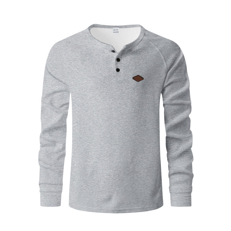 Quick-drying Raglan Henry Long Sleeve in gray with a buttoned collar and chest emblem.