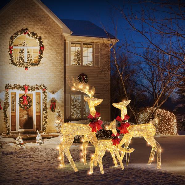 Golden Elk Family Courtyard Elk Decoration with festive lights and bows in a winter outdoor setting.