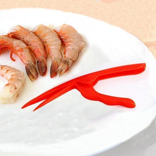 Shrimp Peeler Kitchen Appliances for quick and easy shrimp peeling on a plate with fresh shrimp.