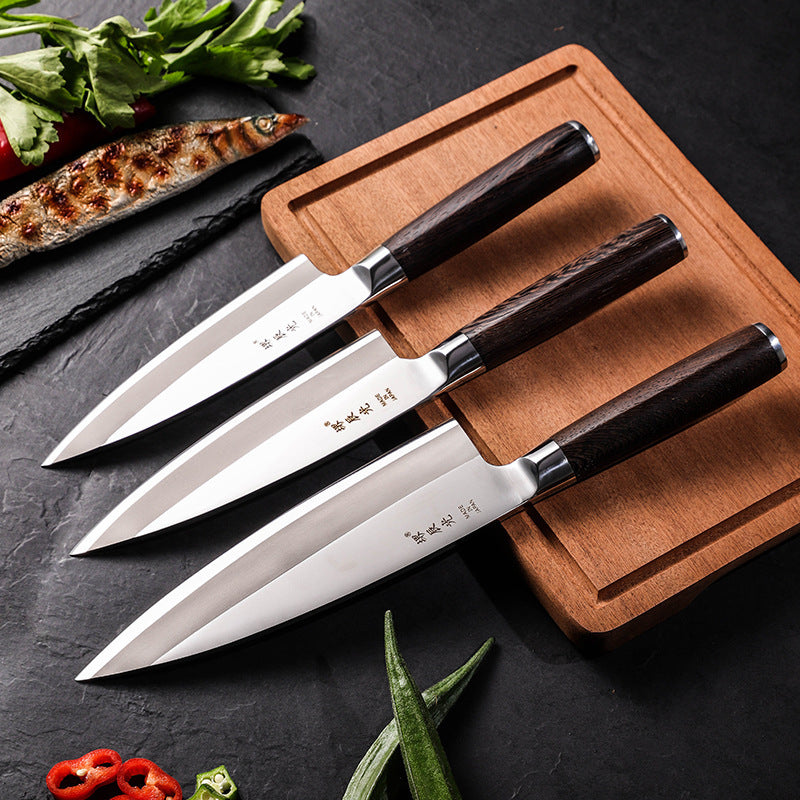 Kitchen Japanese Cooking Knife Chopping Fish Head set on wooden cutting board with fresh vegetables.