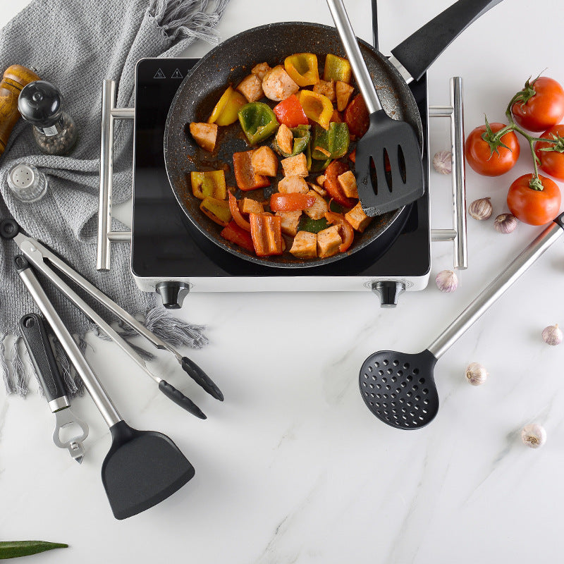 Kitchen Gadgets Cooking Silicone Spatula Spoon Set used in a frying pan with vegetables on a modern stovetop.