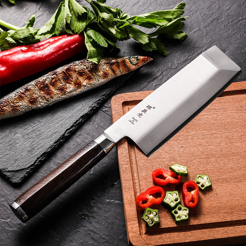 Kitchen Japanese Cooking Knife Chopping Fish Head on a cutting board with fresh vegetables and grilled fish.